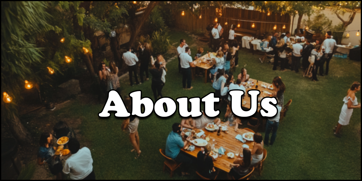 A group of people are gathered outdoors in a garden setting, standing and sitting around tables with food, under string lights. The words "About Us" overlay the image.